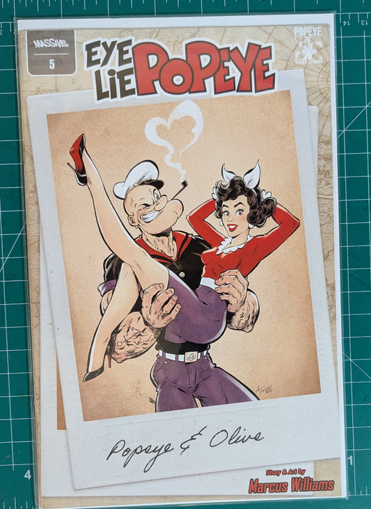 A comic book or art print featuring Popeye and Olive from Eye, Lie, and Popeye, displayed on a green cutting mat. The cover shows Popeye carrying Olive in a classic retro illustration style with the title 'Eye Lie Popeye' at the top.